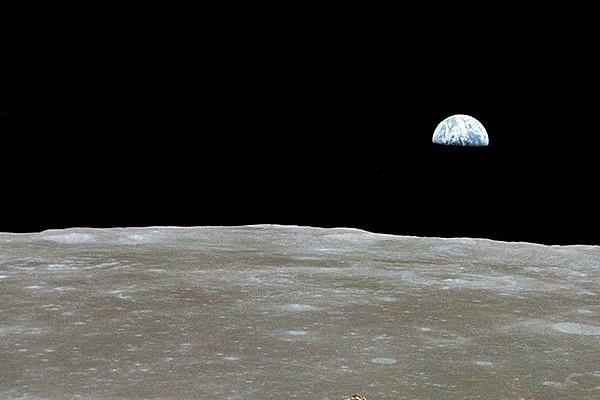 Over the Moon, with a half-Earth in the background. (NASA/Newsmakers)
