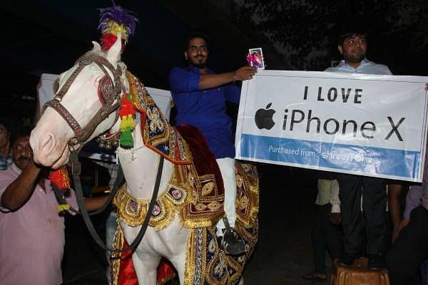 A 21-year-old Thane resident, Mahesh Palliwal, buys the first i phone X in Thane amid a huge procession (Photo by Praful Gangurde/Hindustan Times via Getty Images)