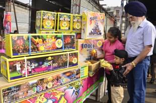 Children buy fireworks and crackers ahead of Diwali festival at a market in New Amritsar. (Sameer Sehgal/Hindustan Times via GettyImages) 