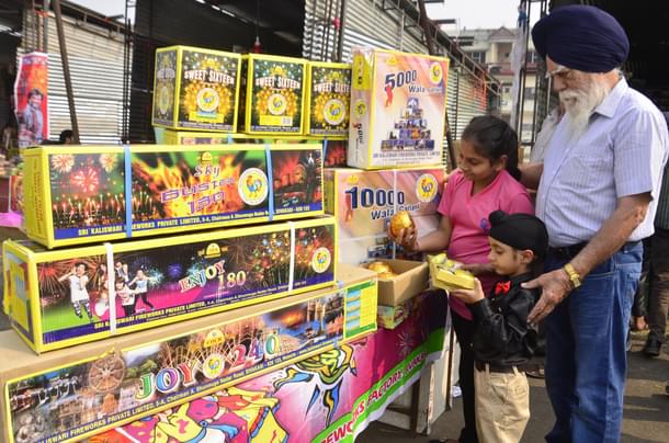 Children buy fireworks and crackers ahead of Diwali festival at a market in New Amritsar. (Sameer Sehgal/Hindustan Times via GettyImages) 