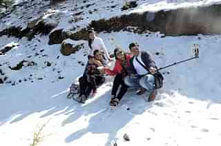  A Family on a vacation clicking a selfie at Shimla in 2018. A study reveals 41 per cent of Indians are unable to go on holidays. (Deepak Sansta/Hindustan Times via Getty Images)