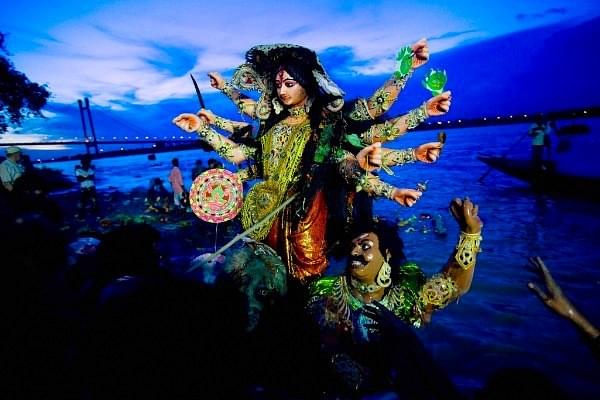Devotees carry an idol of Hindu goddess Durga before immersing it in the river Ganges during the Durga Puja festival in Kolkata, India. (Daniel Berehulak/Getty Images)