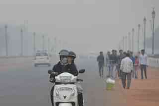Delhi residents make their way through heavy smog. (Photo by K Asif/India Today Group/Getty Images)