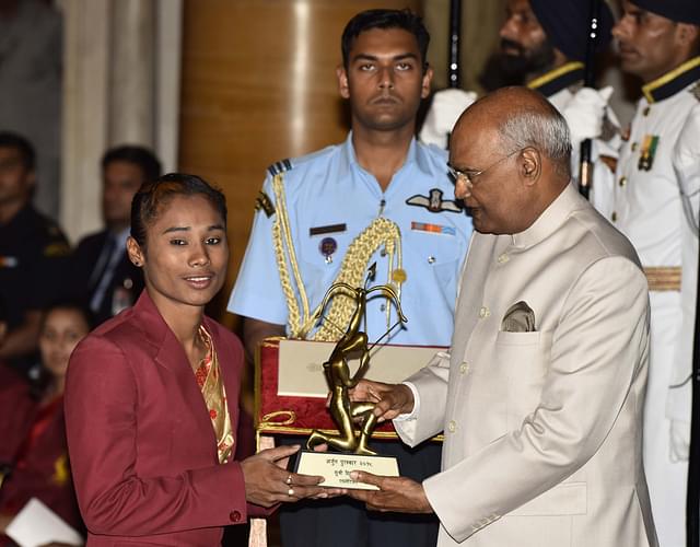 Athletics Hima Das receives Arjuna Award 2018 for her achievements in Athletics from President Ramnath Kovind during the National Sports and Adventure Award 2018 function, at Rashtrapati Bhawan. (Vipin Kumar/Hindustan Times via Getty Images)