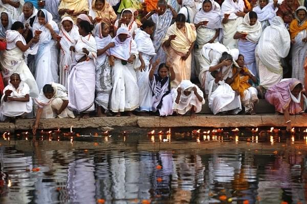 Widows of Vrindavan lighting earthen lamps at the banks of Yamuna River as they begin their three-day Diwali celebrations in Vrindavan, India. (Ajay Aggarwal/Hindustan Times via Getty Images)