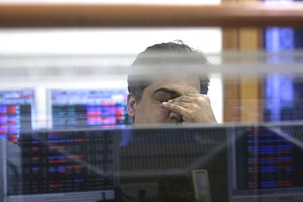 A trader at his desk viewing stock prices. (Indranil Bhoumik/Mint via Getty Images)
