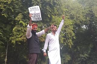 SAD MLA Manjinder Singh Sirsa (Left) Holding Placard Demanding Justice For Anti Sikh Riots’ Victims (@mssirsa/Twitter)