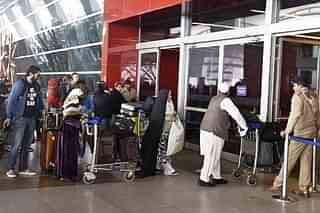 Passengers waiting to enter Delhi Airport (Sushil Kumar/Hindustan Times via Getty Images)