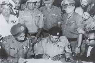 Lt Gen Niazi signing the Instrument of Surrender under the gaze of Lt Gen Arora. (Pic Via Indian Navy)