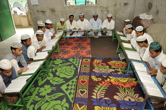 Muslim children reciting verses from Islam’s holy book Quran on the 13th day of Ramadan at a Madrasa (School) on July 21, 2013 in Noida. (Photo by Burhaan Kinu/Hindustan Times via Getty Images)