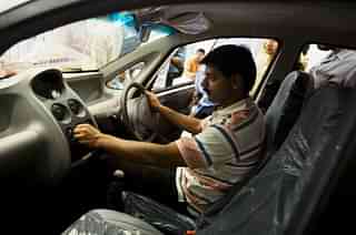 A customer checks out a car at a showroom in New Delhi (Daniel Berehulak/Getty Images)