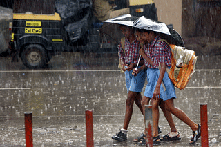 School children on their way back home on a rainy afternoon. (Manoj Patil/Hindustan Times via Getty Images)