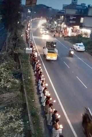 Thousands of devotees lining up near a highway to participate in the Ayyappa Jyoti programme