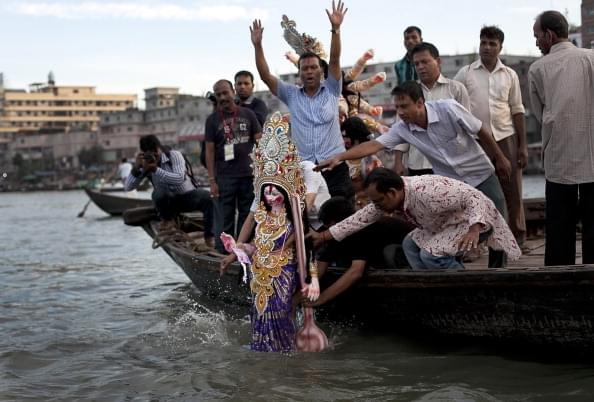 Hindu devotees in Bangladesh immerse a clay idol in the Buriganga River on the last day of Durga Puja in Dhaka. (Photo by Getty Images/Getty Images) 
