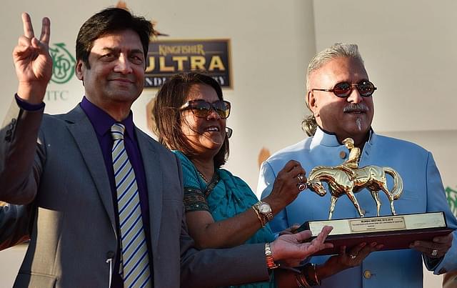 Vijay Mallya presents the winner trophy to the owner of the Indian Derby winning horse Desert God Mr. and Mrs. Padmanabhan during the Indian Derby race at Royal Western India Turf Club on February 7, 2016 in Mumbai. (Photo by Arijit Sen/Hindustan Times via Getty Images)