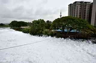 A huge pile of froth on the polluted Bellandur Lake near the residential houses on August 17, 2017 in Bengaluru. (Arijit Sen/Hindustan Times via Getty Images)