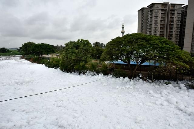 A huge pile of froth on the polluted Bellandur Lake near the residential houses on August 17, 2017 in Bengaluru. (Arijit Sen/Hindustan Times via Getty Images)