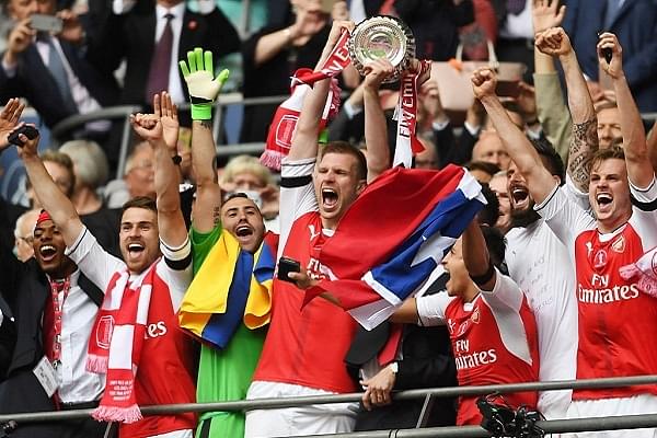Arsenal celebrating with the FA Cup trophy in 2017, having won it a record 13 times (Laurence Griffiths/Getty Images)
