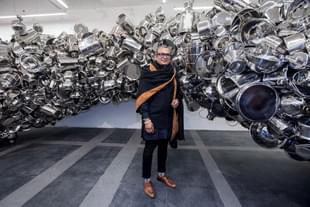 Subodh Kumar posing with one of his works in New Delhi. (Photo by Graham Crouch Getty Images for Subodh Gupta/Hauser & Wirth )