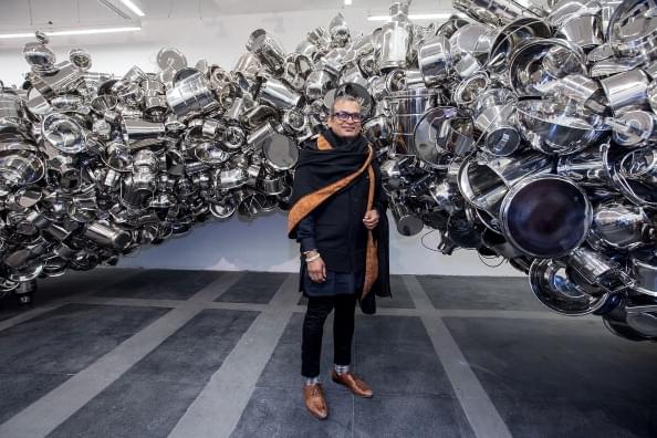 Subodh Kumar posing with one of his works in New Delhi. (Photo by Graham Crouch Getty Images for Subodh Gupta/Hauser & Wirth )