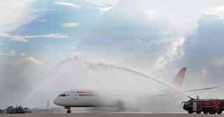 The Air India’s Boeing 787-800 Dreamliner is been given a traditional water cannon salute by the fire tenders upon its arrival at the airport.  (Parveen Negi/India Today Group/Getty Images)
