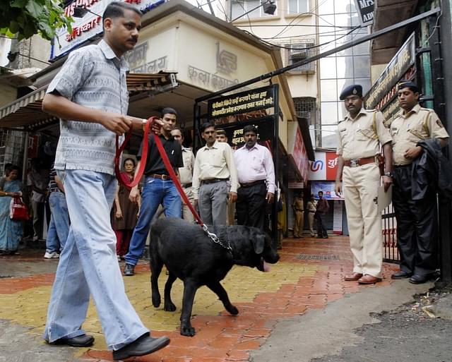 (Representative image) Police with a sniffer dog outside a robbed bank (Photo by Kalpak Pathak/Hindustan Times via Getty Images)