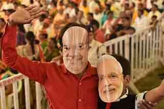 BJP workers wearing masks of Prime Minister Narendra Modi and party President Amit Shah (Mujeeb Faruqui/Hindustan Times via Getty Images)