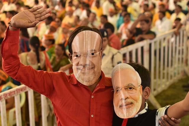 Representative image of BJP workers wearing masks of Amit Shah and PM Modi (Mujeeb Faruqui/Hindustan Times via Getty Images)