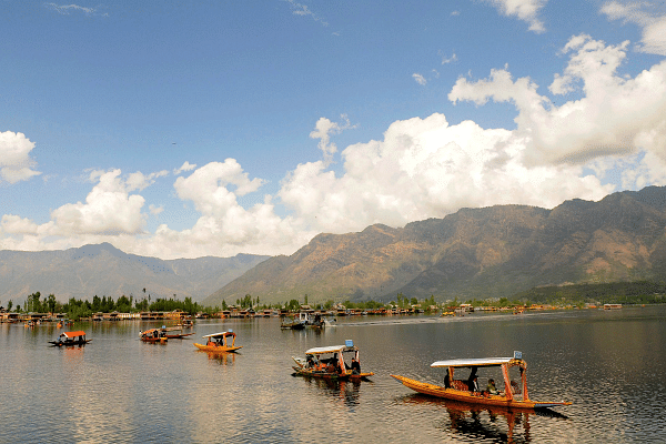 Tourists enjoy shikara ride on the waters of Dal Lake in Srinagar. (Waseem Andrabi/Hindustan Times via Getty Images)