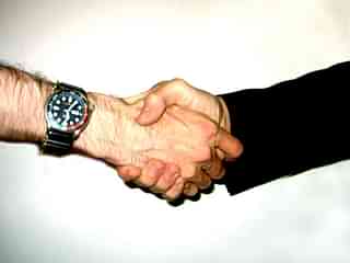 Representative image of two individuals shaking hands. (Lucas/Wikimedia Commons)