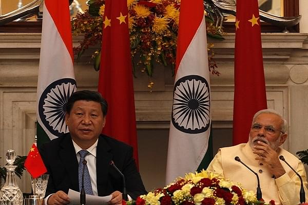 Prime Minister Narendra Modi and Chinese President Xi Jinping (L) (Arvind Yadav/Hindustan Times via Getty Images)