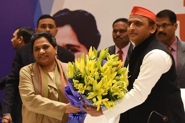 Akhilesh Yadav presents a bouquet to  Mayawati during a joint press conference on 12 January  in Lucknow. (Subhankar Chakraborty/Hindustan Times via GettyImages)&nbsp;