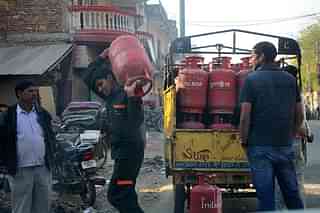Customers picking up their LPG cylinders in New Delhi (Priyanka Parashar/Mint via Getty Images)