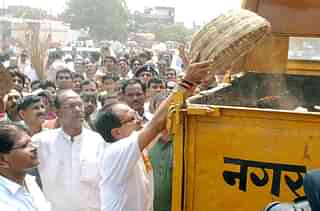 Former Chief Minister Shivraj Singh Chouhan collecting garbage as part of the Swachh Bharat Abhiyan at Chhola Dussehra ground on October 2, 2014 in Bhopal. (Photo by Mujeeb Faruqui/Hindustan Times via Getty Images)