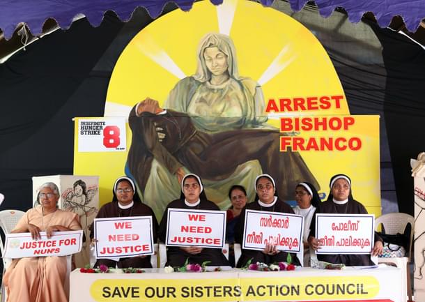 Nuns hold placards during a protest demanding the arrest of Bishop Franco Mullakal of Jalandhar. (Vivek Nair/Hindustan Times via Getty Images) 