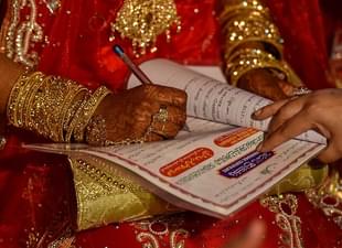 A woman signs a Nikah Nama in Bhopal. (Photo by Kunal Patil/Hindustan Times via Getty Images) 