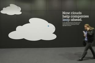 A woman walks past a could computing presentation at the IBM stand  in Hanover, Germany. (Sean Gallup/GettyImages) 