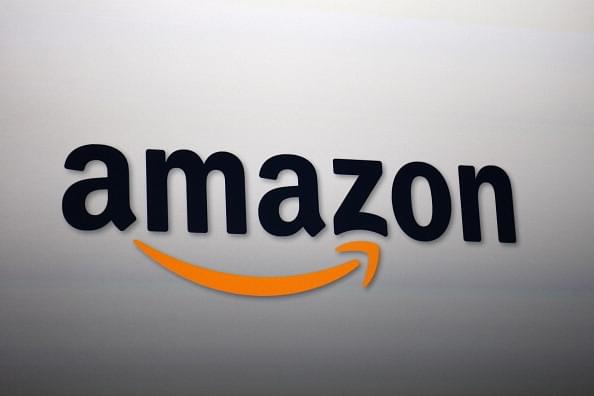 The Amazon logo being projected on a screen. (Photo by David McNew/Getty Images)
