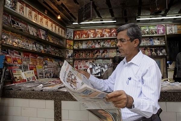 A person reading a newspaper. (Photo by Kalpak Pathak/Hindustan Times via Getty Images) &nbsp;