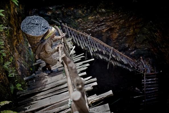 A coal mine worker in Meghalaya. Despite the NGT banning coal mining in Meghalaya, the state government was unable to curb it and now has received a Rs 100 crore fine. (representative image) (Photo by Daniel Berehulak/Getty Images)