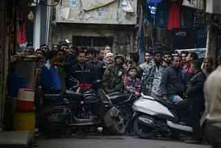 A crowd gathers at Seelampur’s Jafrabad locality during the NIA raid on 26 December 2018 in New Delhi. (Sanchit Khanna/ Hindustan Times via Getty Images)