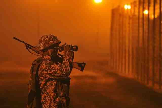 An Indian Army soldier stands guard at the International border in Jammu. (Nitin Kanotra/Hindustan Times via Getty Images)