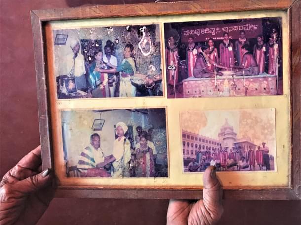 Sukri ajji holds out an old framed photograph of her awards and performances.