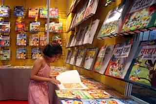 A child reads a book during the 18th Delhi Book Fair at Pragati Maidan in New Delhi on Sunday. (Qamar Sibtain/India Today Group/Getty Images)