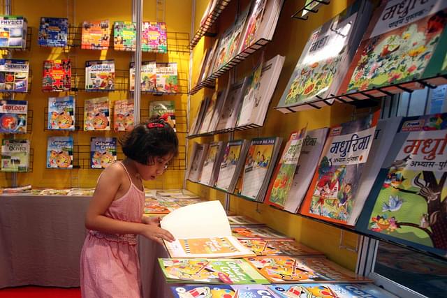 A child reads a book during the 18th Delhi Book Fair at Pragati Maidan in New Delhi on Sunday. (Qamar Sibtain/India Today Group/Getty Images)