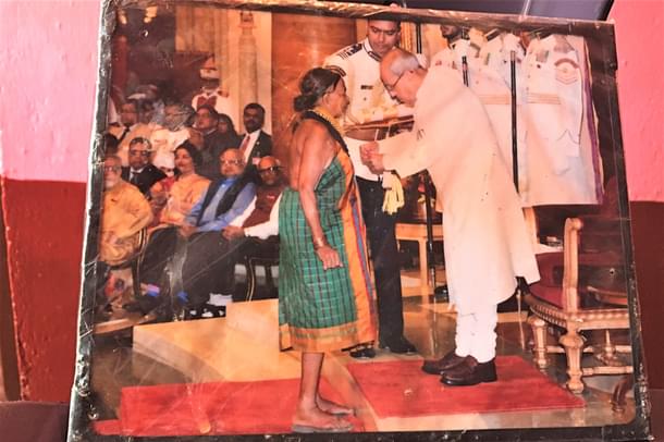 The laminated picture of her Padma award wrapped in plastic.