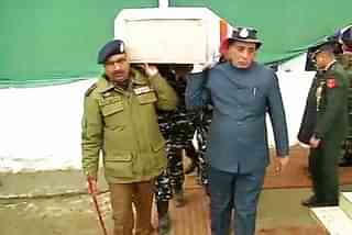 Home Minister Rajnath Singh carrying the remains of a martyred soldier. (@ANI via Twitter)