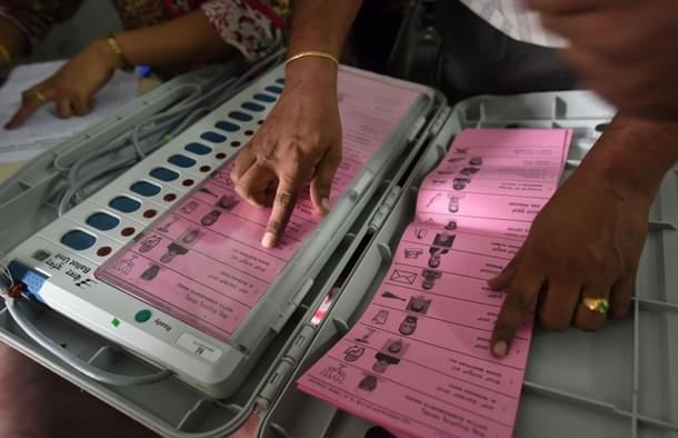 A polling staff tallies the candidates names on the electronic voting machines (Arijit Sen/Hindustan Times via GettyImages)