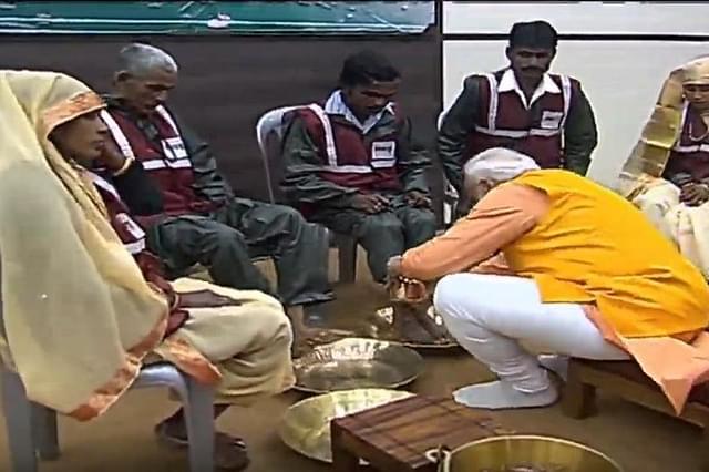 Prime Minister Narendra Modi washing the feet of a sanitary worker.
