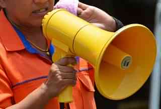 Representative image of a woman using a megaphone. (Pic via Picryl)